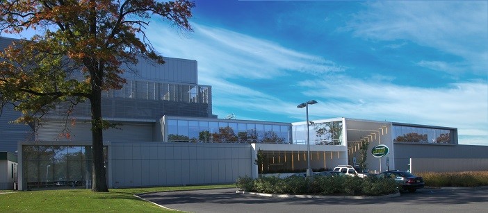 A large building with a parking lot in front of it.